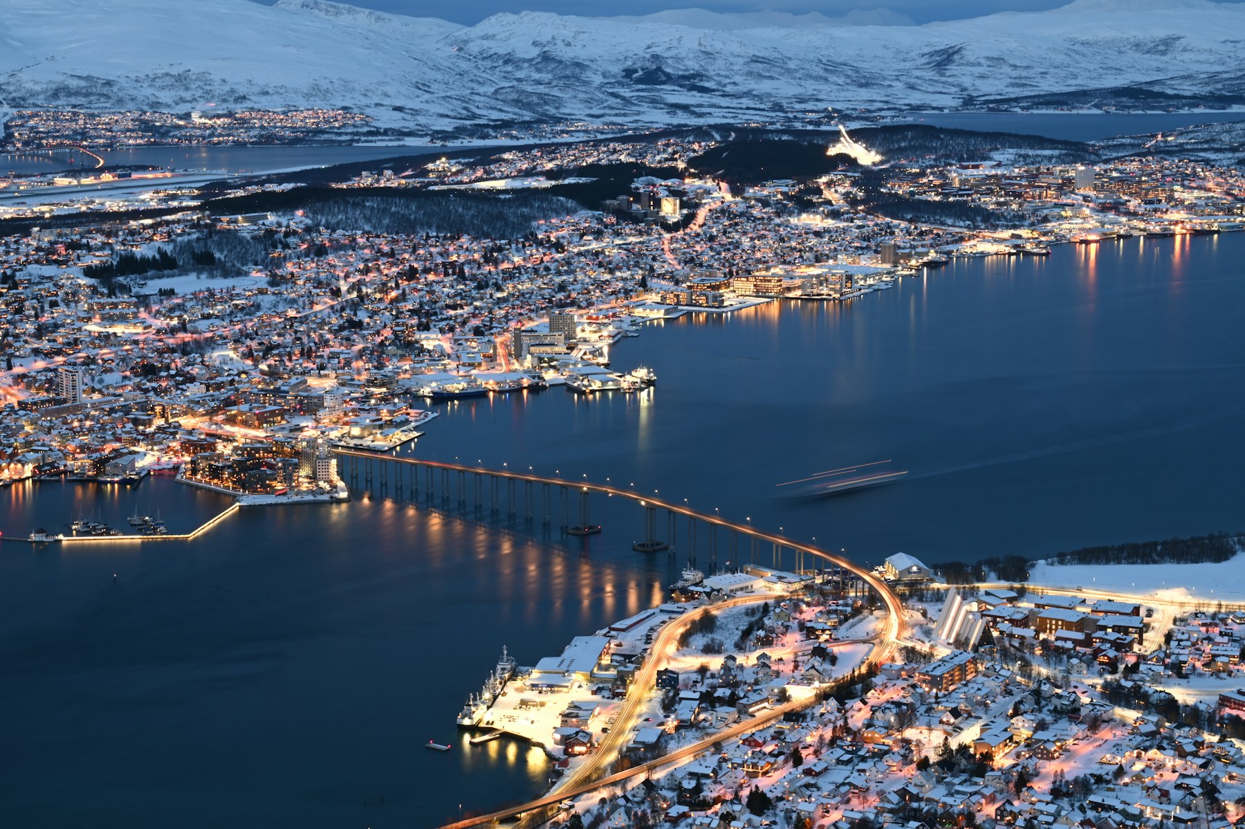 Quiet Arctic water enclosed by snow-covered northern mountains