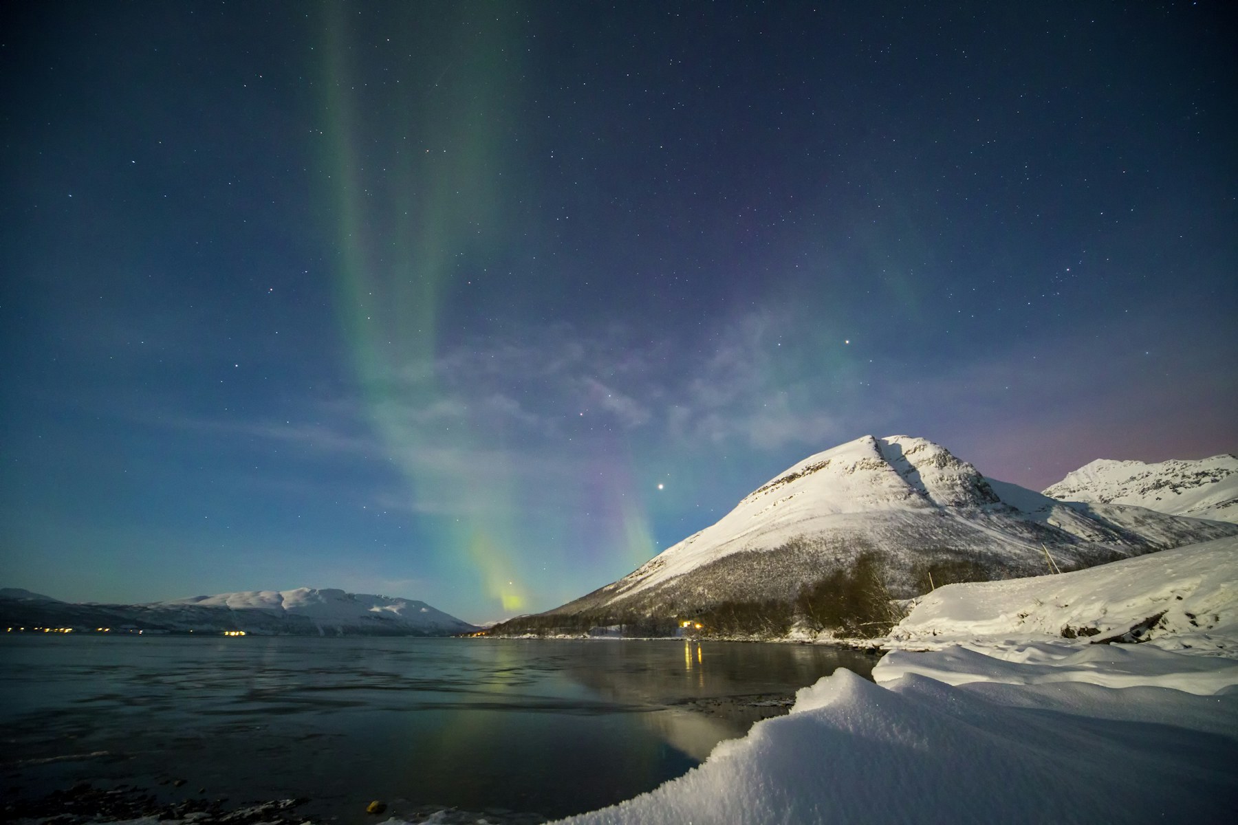 Aurora reflected across dark northern water